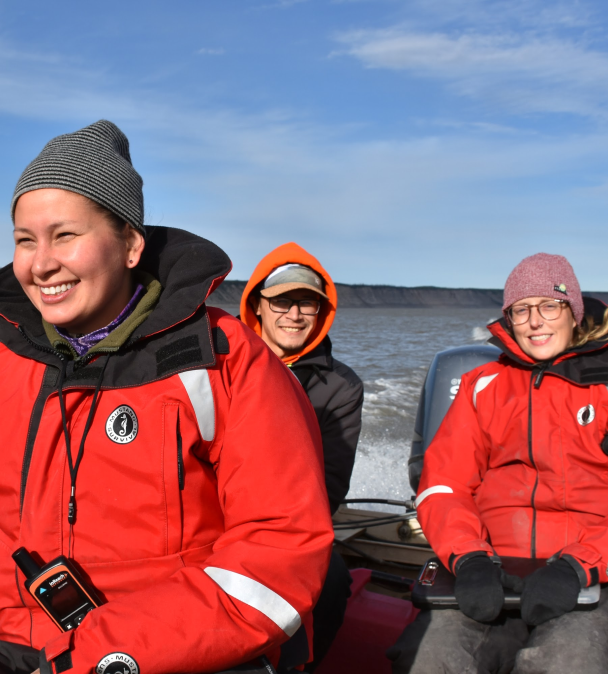 Gila Somers (Government of Northwest Territories) and others in a boat wearing safety vests.