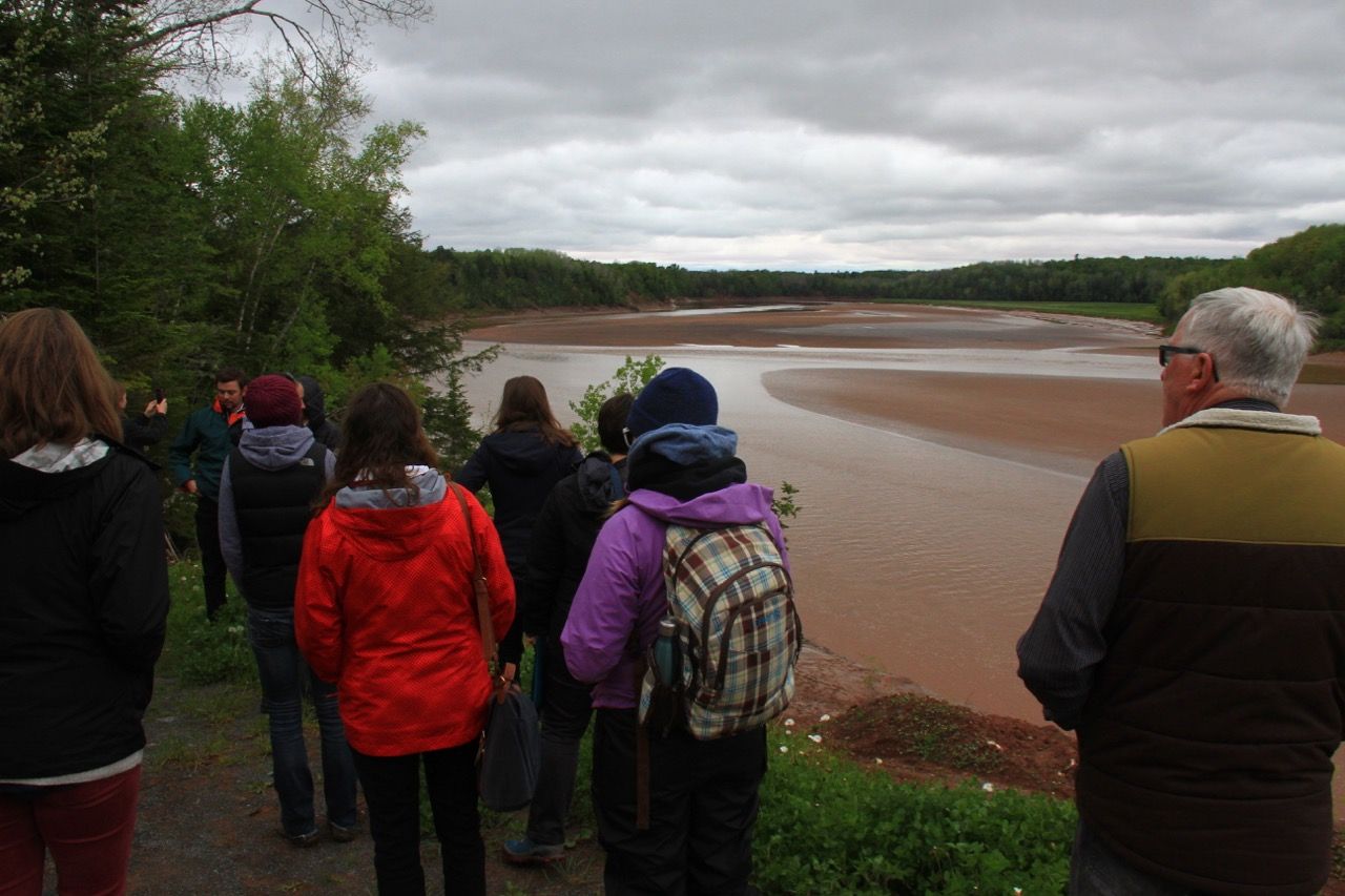 group of people looking out over the Shubenacadie river