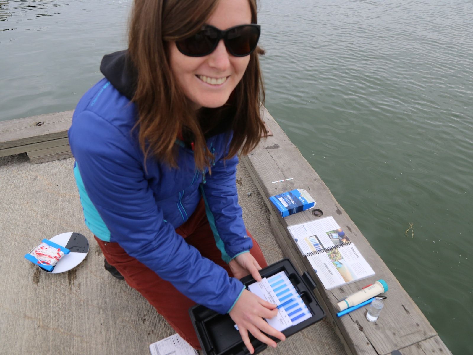 Nicole Goodman monitoring water with test strips.